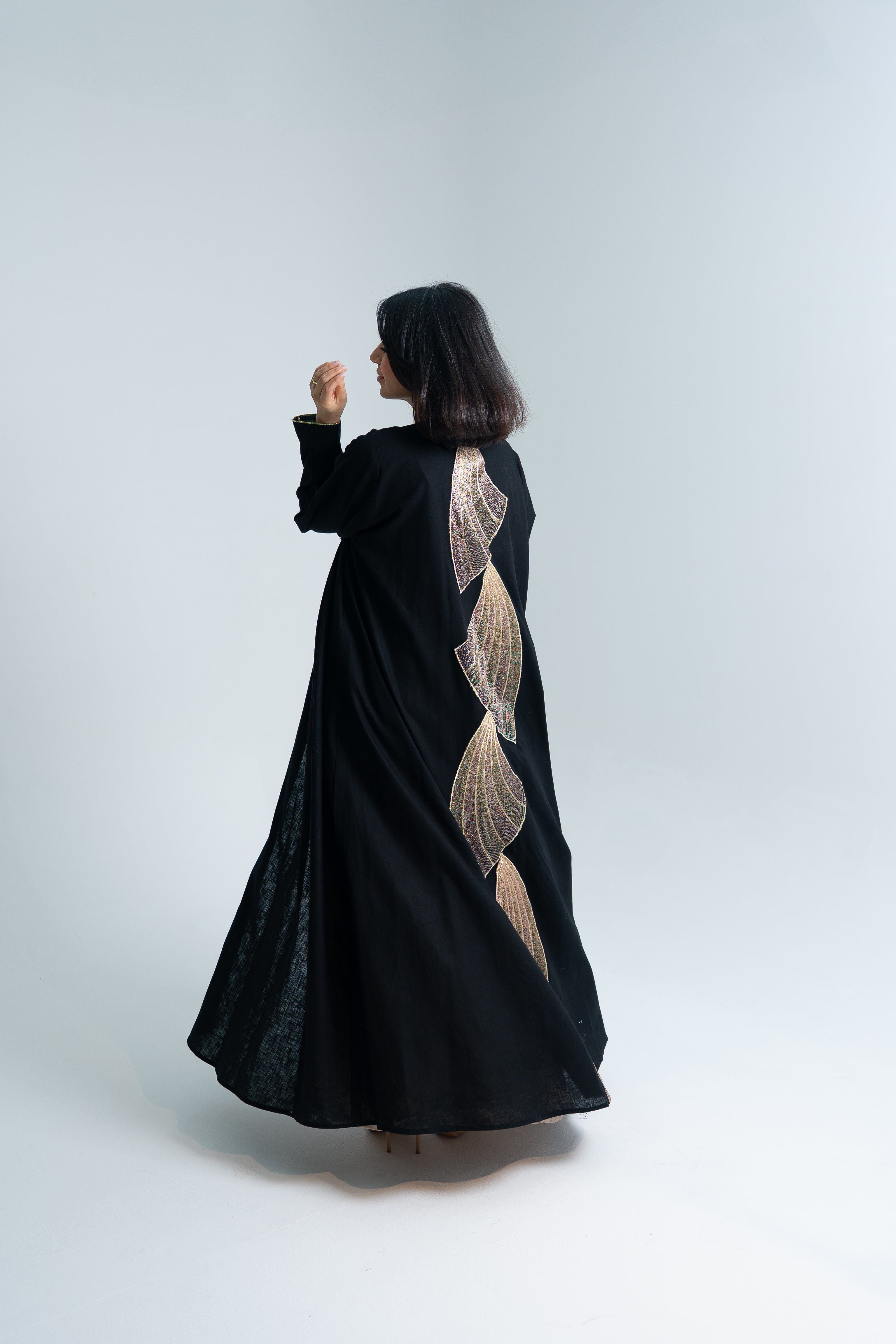 A cut Linen abaya with gold hand embroidery at the back