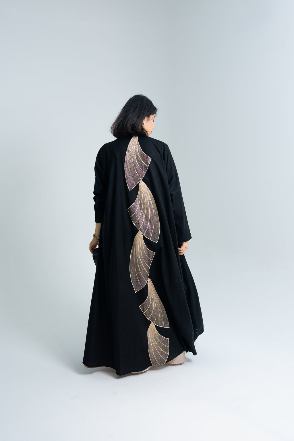 A cut Linen abaya with gold hand embroidery at the back