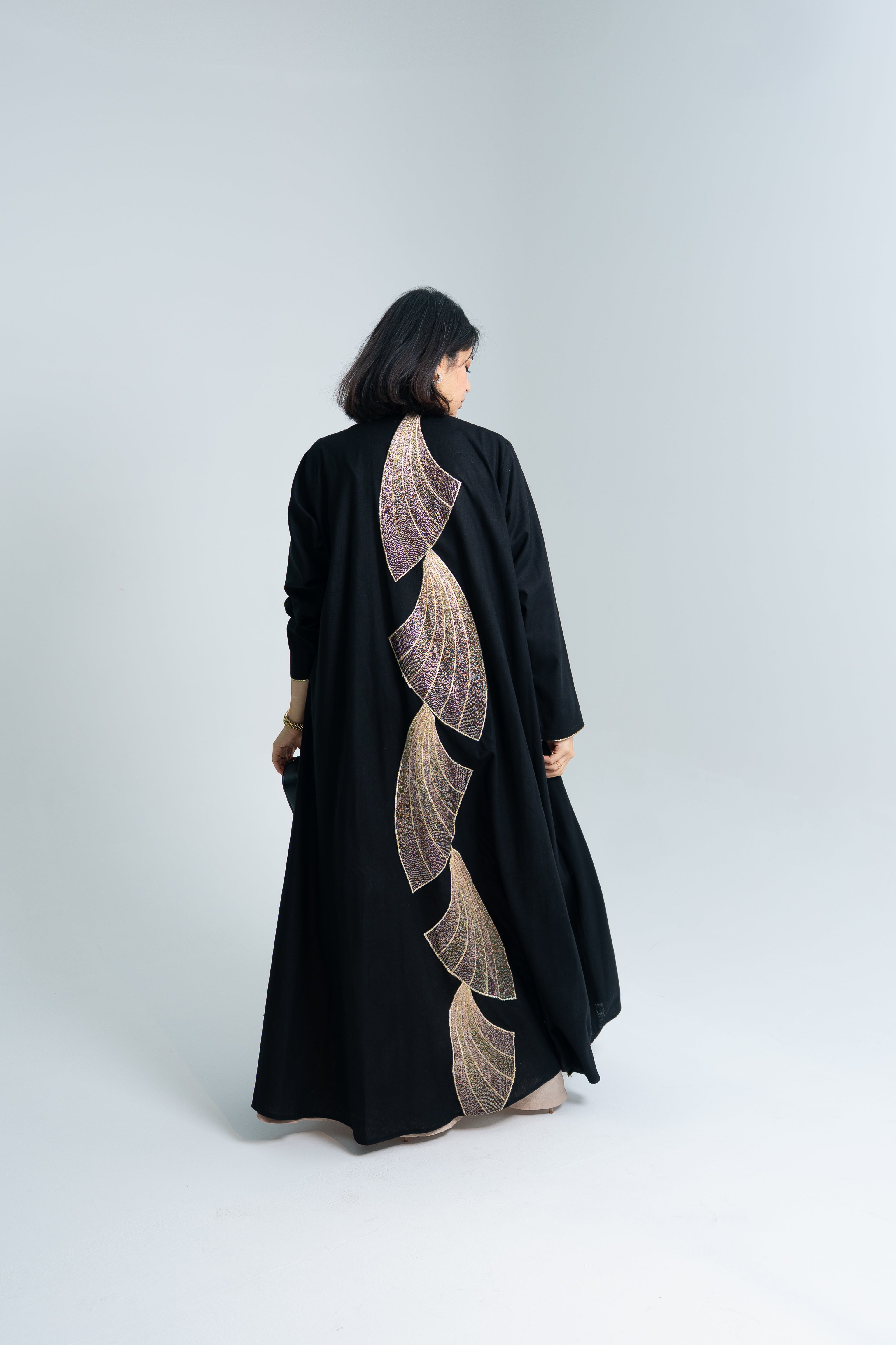 A cut Linen abaya with gold hand embroidery at the back